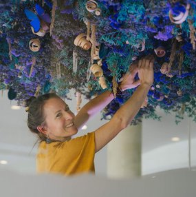 Künstlerin Katharina Steiner bei den Entstehungsarbeiten der kopfüberhängenden Naturinstallation