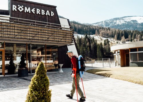 Profi-Snowboarder Alex Payer vor dem Eingang des Thermal Römerbades Bad Kleinkirchheim