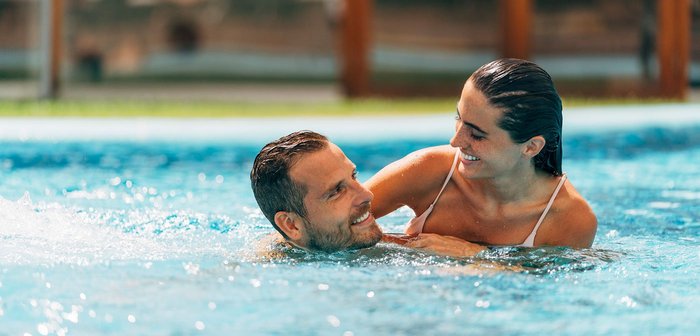 Ein Mann und eine Frau schwimmen gemeinsam in einem Pool.