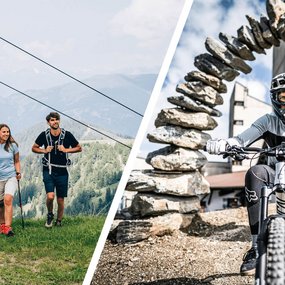 Wanderpärchen mit Kaiserburgbahn im Hintergrund, Mountainbiker vor dem Startportal des Flow Country Trails